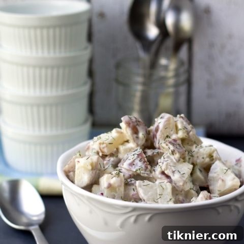 Tangy Red Potato Bacon Salad, a creamy and flavorful side dish with crispy bacon, tender red potatoes, and fresh herbs.