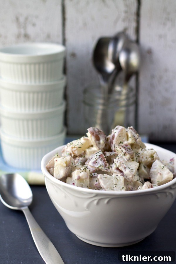Close-up of Tangy Red Potato Bacon Salad in a bowl, showing the texture and ingredients.