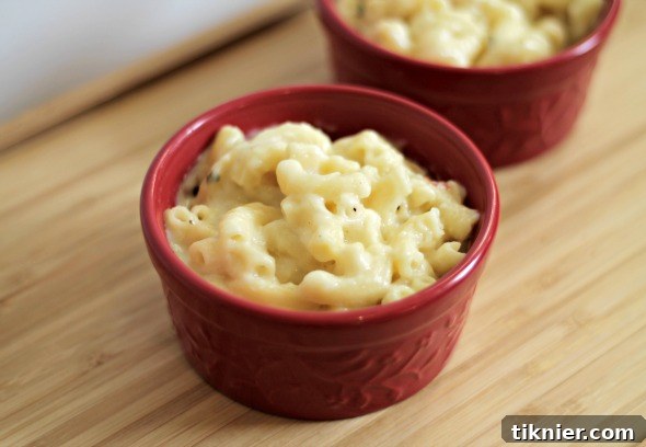 Close-up of a spoonful of Rosemary Pancetta Macaroni and Cheese, showing creamy texture
