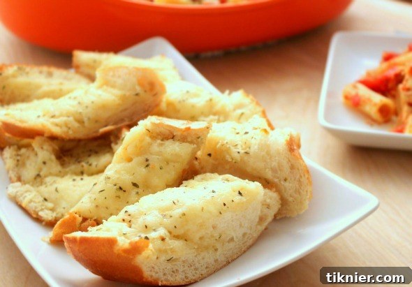 Irresistible Cheesy Garlic Bread, featuring melted cheese and golden crust, by I Heart Eating, perfect for any meal.