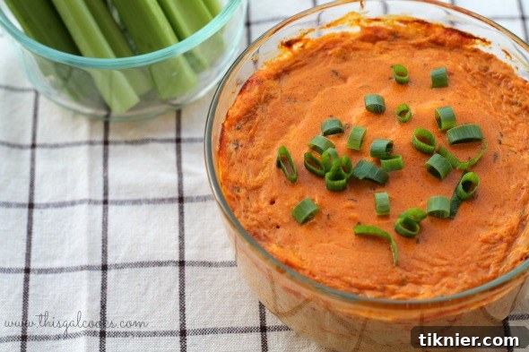 Close-up of baked Buffalo Chicken Dip in a casserole dish.