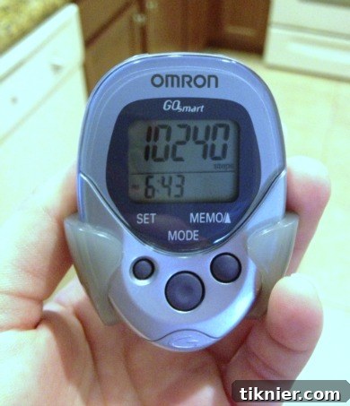 Close-up of a digital pedometer displaying steps, a motivational tool for daily physical activity and fitness goals.