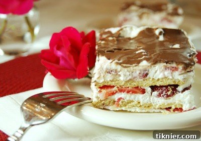 A classic No Bake Strawberry Ice Box Cake, beautifully layered with whipped cream and fresh sliced strawberries, promising a cool and delightful dessert.