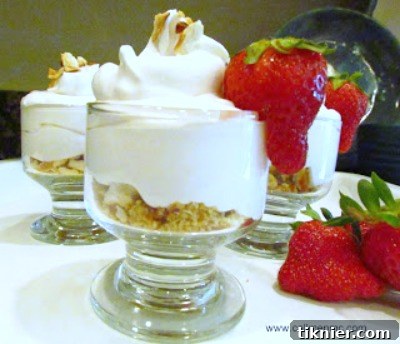 A vibrant No Cook Strawberry Cheesecake, topped with fresh, glistening strawberries, embodying a perfect summer dessert with a creamy texture.