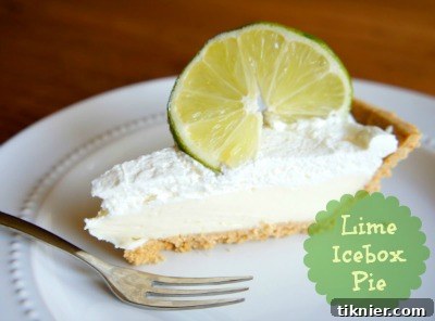 A refreshing Lime Ice Box Pie with a fluffy, vibrant green filling, promising a tangy and cool dessert for hot days.