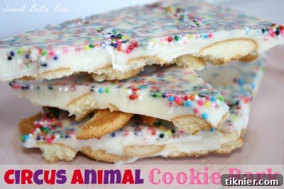 A vibrant and colorful Circus Animal Cookie Bark, featuring white chocolate swirled with sprinkles and pieces of frosted animal cookies, creating a playful and easy-to-make treat.
