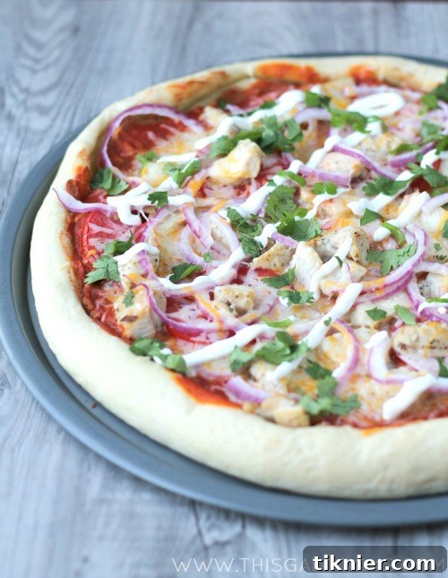 Close-up of the healthy Chicken Enchilada Pizza with Tyson Grilled & Ready chicken and fresh vegetables.