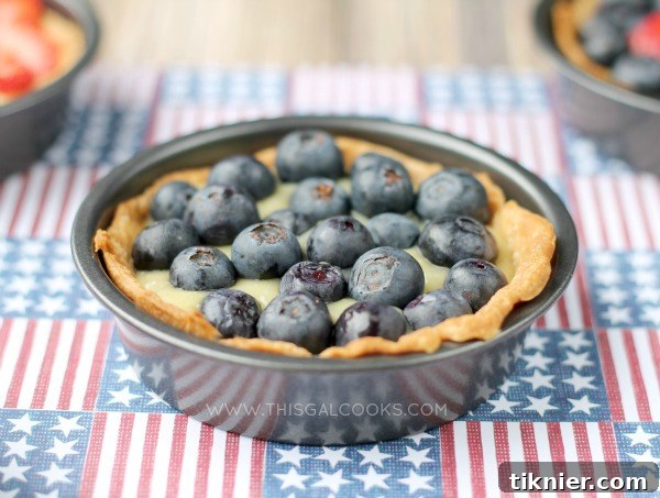 Assortment of mini Dairy-Free Fruit Tarts with various fresh berries, beautifully arranged on a serving plate for a festive occasion