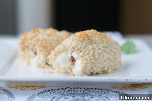 Close-up of baked Caprese Chicken Rollups, showing melted cheese and fresh basil