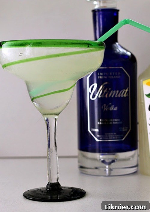 Glass of Ultimate Lemonade with lemon slices and mint