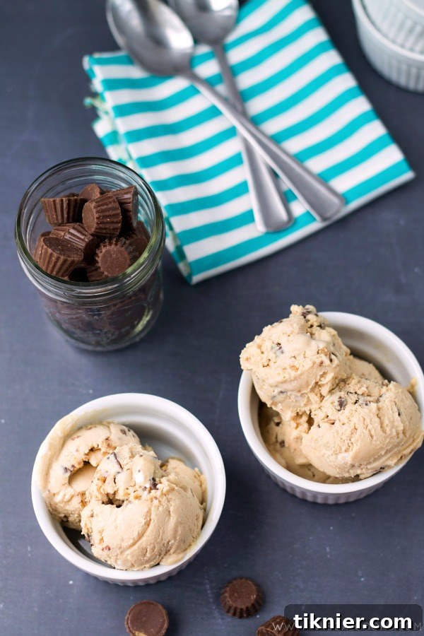 Fluffernutter Peanut Butter Cup Ice Cream. Homemade Ice Cream made with peanut butter, marshmallow fluff and peanut butter cups! From www.thisgalcooks.com #peanutbutter #icecream
