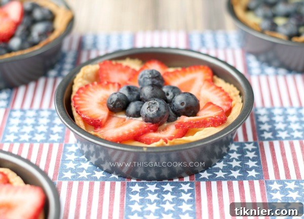 10 Incredible Fruit Delights 6 Elegant Fresh Fruit and Cream Tarts, dairy-free, featuring a vibrant assortment of seasonal fruits atop a creamy filling in a crisp tart shell.