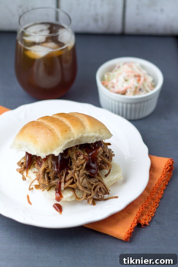 A delicious Crockpot BBQ Beef Sandwich with fresh ingredients