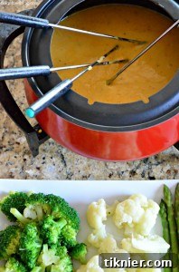 A rich and bubbly Craft Beer Cheese Fondue, served with crusty bread and other dipping delights.