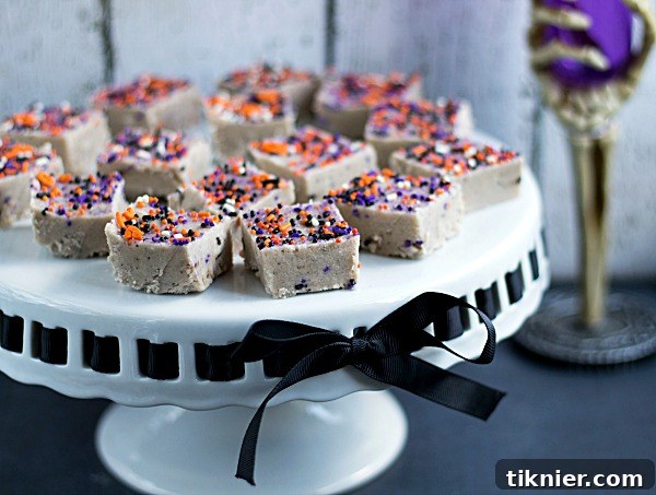 Trick-or-Treat Cake Batter Fudge 6 A tray of Halloween Cake Batter Fudge squares, ready to be served at a festive party.