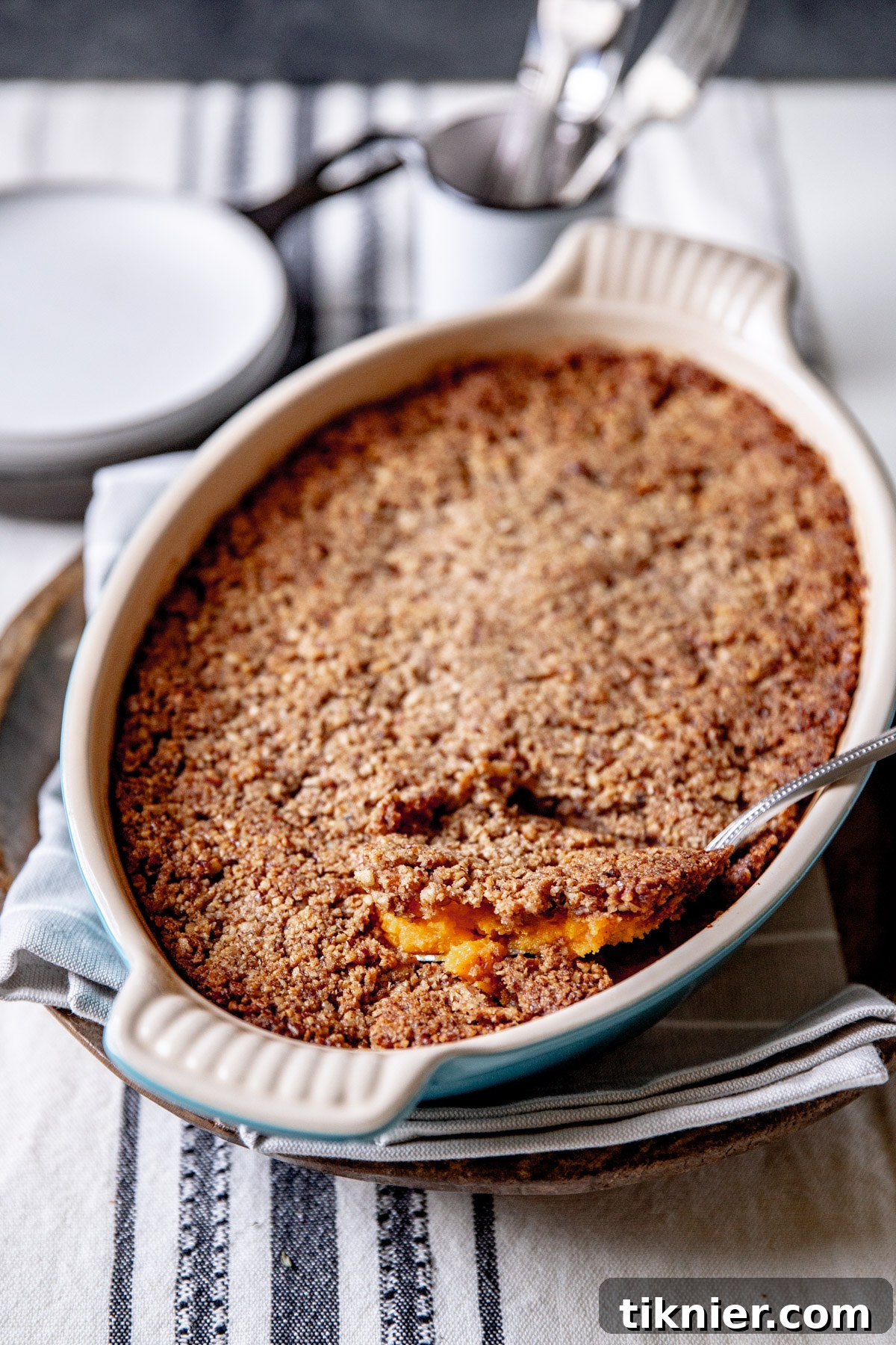 Delicious and fluffy sweet potato casserole with a golden pecan streusel topping, ready for holiday dinners.