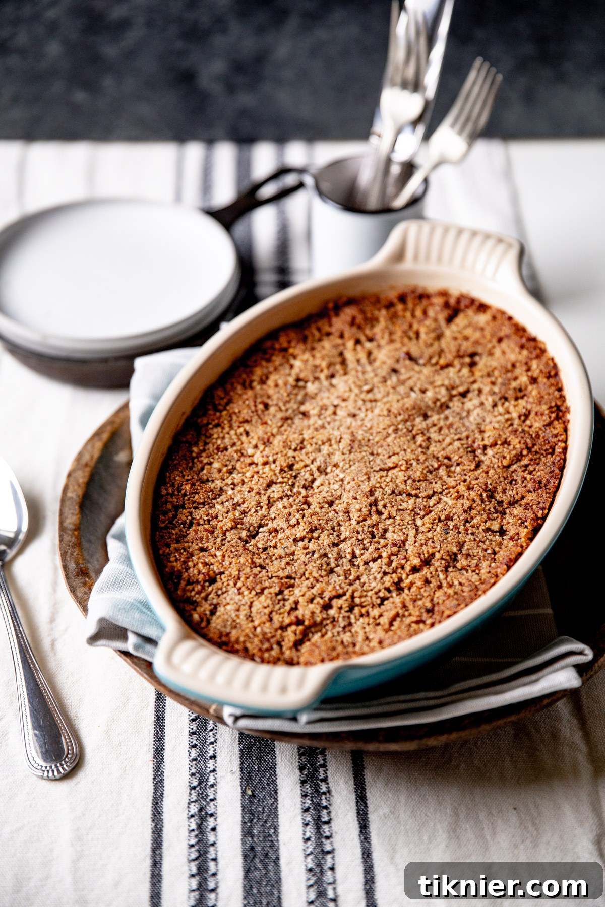 A freshly baked sweet potato casserole, still warm from the oven, with a glistening pecan streusel topping.