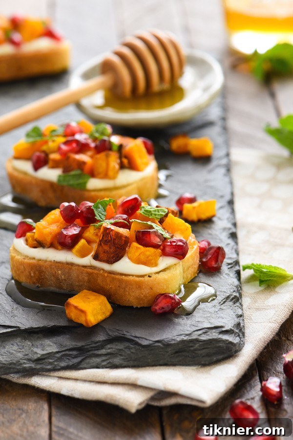 Festive Butternut Squash Pomegranate Crostini with Whipped Feta, perfect for autumn holidays.