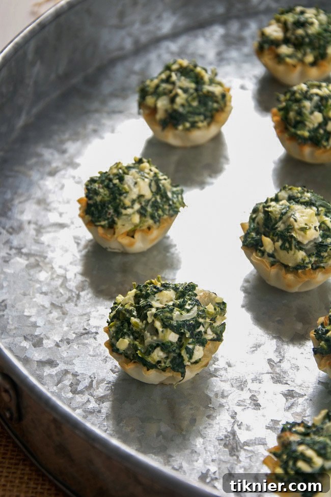 Crispy Spanakopita Tarts, a savory Mediterranean-inspired appetizer for festive occasions.