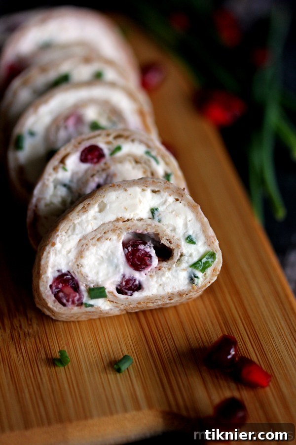 Colorful Pomegranate and Feta Pinwheels, a festive and fresh appetizer that pops.