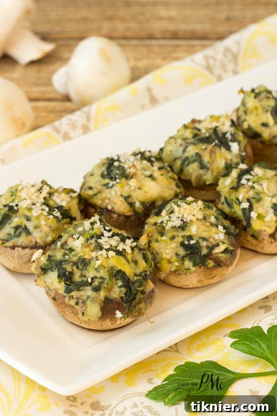 Savory Spinach Artichoke Stuffed Mushrooms, a popular holiday starter that's always a hit.