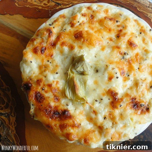 Savory Artichoke Roasted Garlic Dip, an easy crowd-pleasing appetizer with rich flavors.