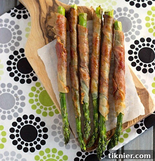 Elegant Prosciutto Wrapped Asparagus, a simple yet sophisticated appetizer with savory notes.