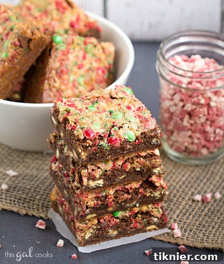 A festive close-up of Mocha Peppermint Cookie Bars on a cooling rack, showcasing the rich chocolate base and colorful toppings