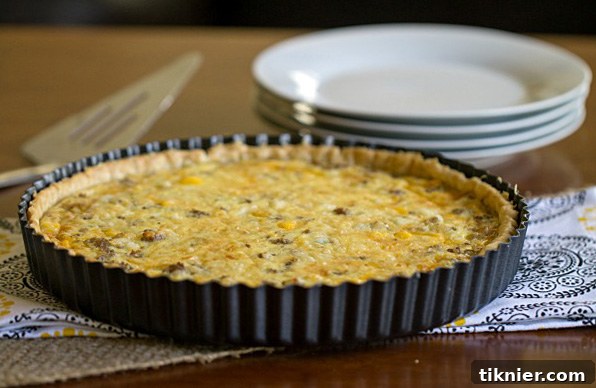 Closeup of a slice of Sausage Egg and Cheese Quiche, ready to serve.