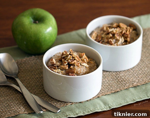 Bowl of Apple Pie Oatmeal garnished with pecans and flax seeds, an easy vegan breakfast