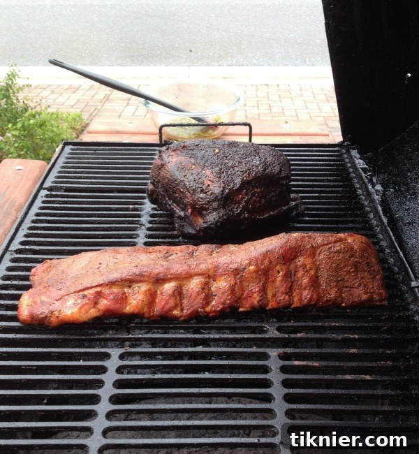 Close-up of slow-smoked Boston Butt Roast and Baby Back Ribs on a grill