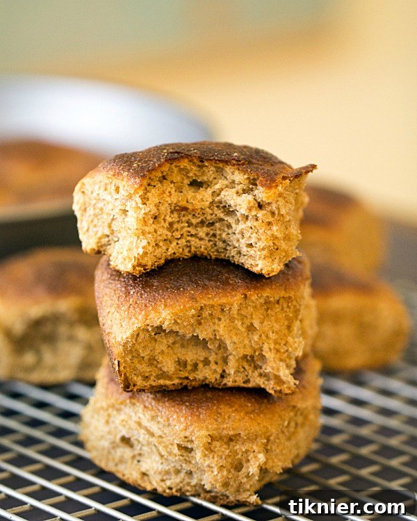 Freshly baked Whole Wheat Dinner Rolls on a cooling rack