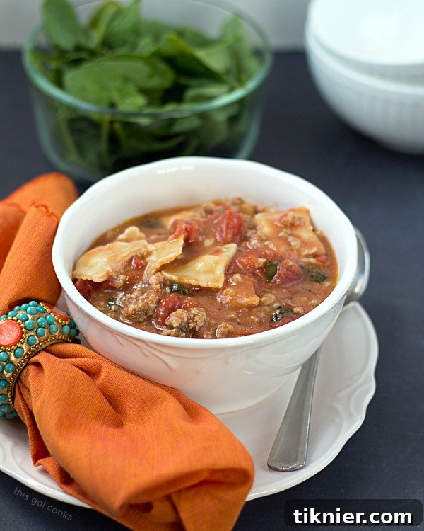 Full bowl of Easy Ravioli Soup, garnished with fresh basil, ready to be enjoyed as a comforting family meal.