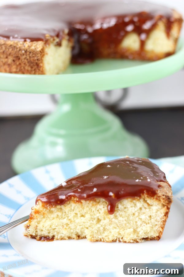 Slice of Hazelnut Cake with Salted Caramel Sauce on a lime green cake plate