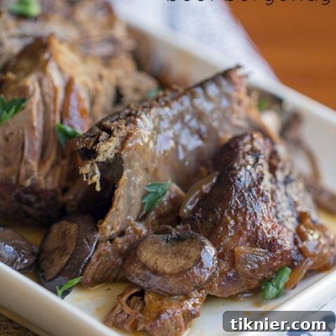 Crock Pot Beef Burgundy recipe, featuring a slow-cooked beef roast with red wine, onions, and mushrooms for a rich and tender meal.