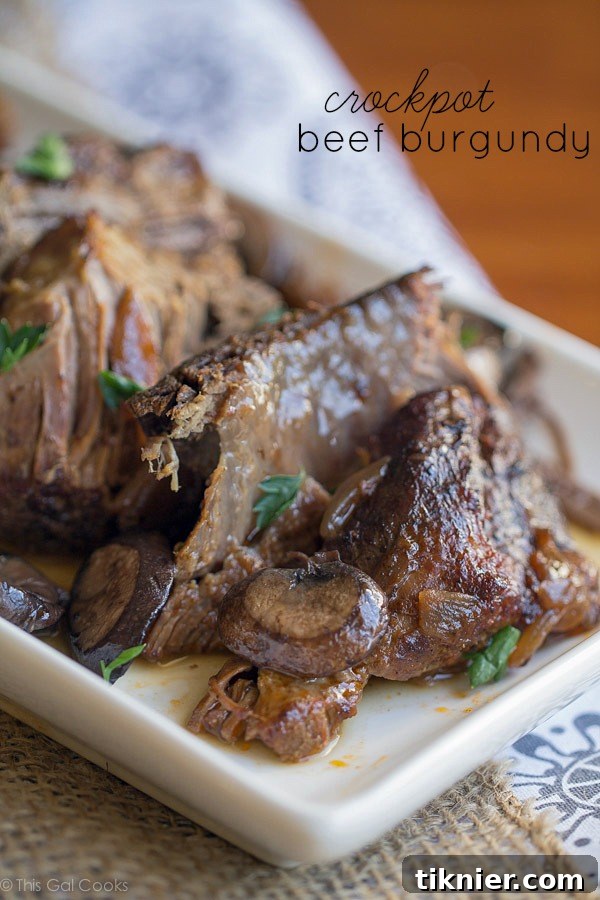 Delicious Crock Pot Beef Burgundy, a slow-cooked beef stew rich with red wine, mushrooms, and savory flavors, garnished with fresh parsley.