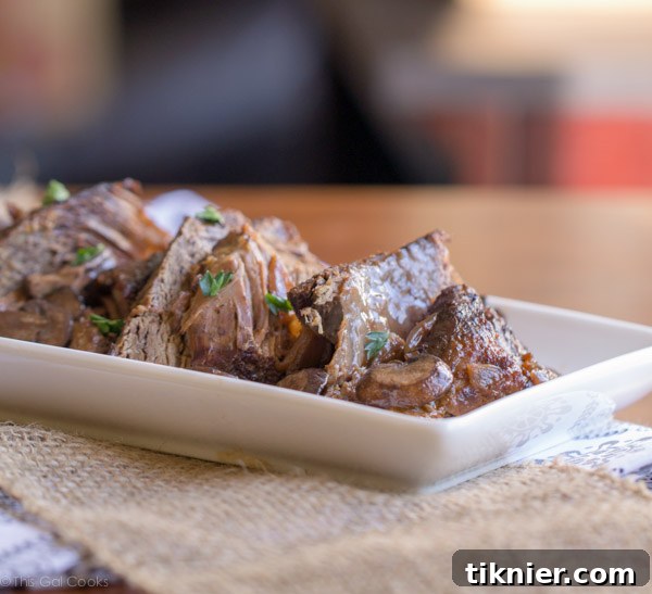 Crock Pot Beef Burgundy, a hearty slow-cooked beef stew with red wine, onions, and mushrooms. Delicious comfort food for family dinners. | This Gal Cooks