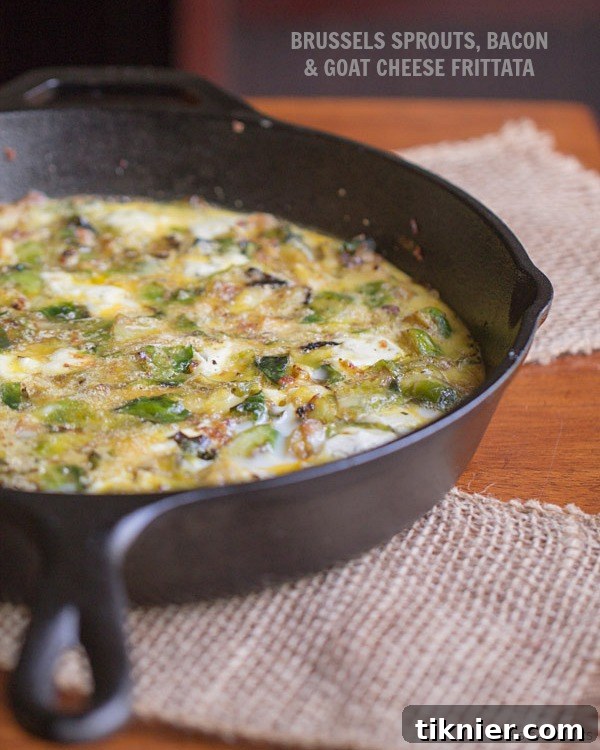 A top-down view of the freshly baked Brussels Sprouts, Bacon and Goat Cheese Frittata, ready to serve.