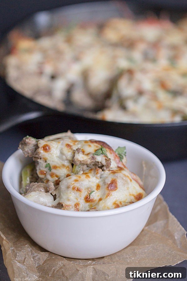 30-Minute Cheesesteak Gnocchi Casserole 4 Detailed shot of the Philly Cheeseburger Gnocchi Bake in an oven-safe skillet, showing the rich texture of the beef, gnocchi, and melted cheese before baking.
