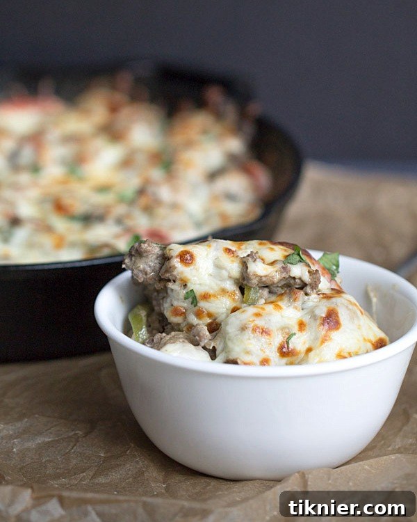 30-Minute Cheesesteak Gnocchi Casserole 9 Philly Cheeseburger Gnocchi Bake served on a plate with fresh cilantro, highlighting the hearty portion and inviting texture.