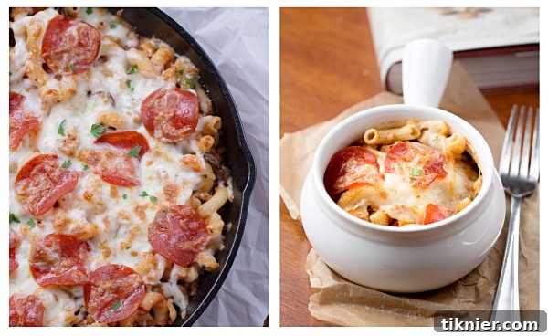 A serving spoon lifting a portion of Skillet Pizza Pasta Bake from a cast iron skillet, showcasing the cheesy layers and ingredients.