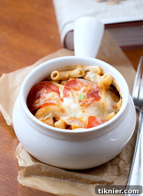 Overhead view of the Skillet Pizza Pasta Bake in a cast iron skillet, showcasing the even topping of pepperoni and cheese.