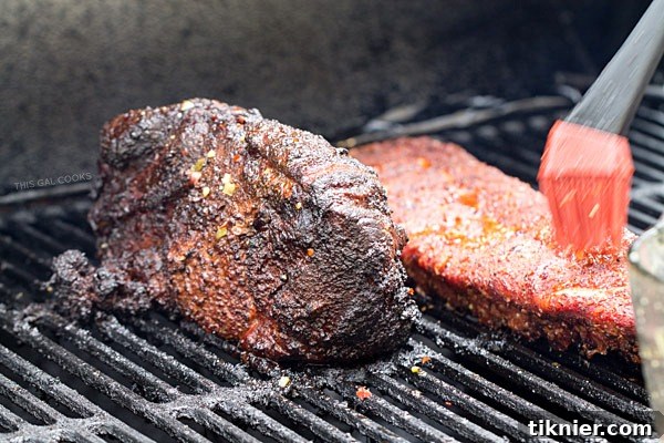 Essential tools for a perfect BBQ Day: a smoker and grill, ready for delicious meats.