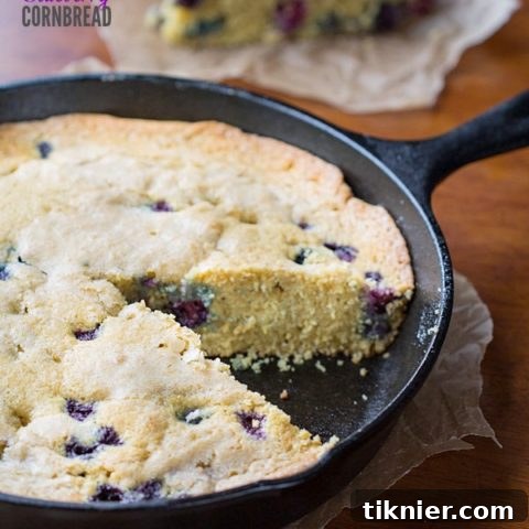 Blueberry Cornbread baked in a cast iron skillet.