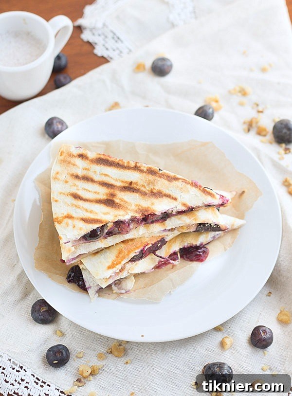 Creamy brie cheese, walnuts and fresh blueberries come together to make this crazy good Blueberry Brie Walnut Quesadilla. Perfect for breakfast or dessert!