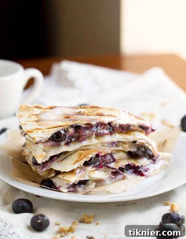 Creamy brie cheese, walnuts and fresh blueberries come together to make this crazy good Blueberry Brie Walnut Quesadilla. Perfect for breakfast or dessert!