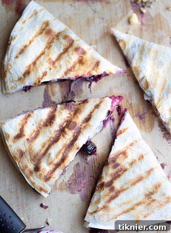 Creamy brie cheese, walnuts and fresh blueberries come together to make this crazy good Blueberry Brie Walnut Quesadilla. Perfect for breakfast or dessert!