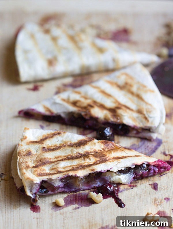 Creamy brie cheese, walnuts and fresh blueberries come together to make this crazy good Blueberry Brie Walnut Quesadilla. Perfect for breakfast or dessert!