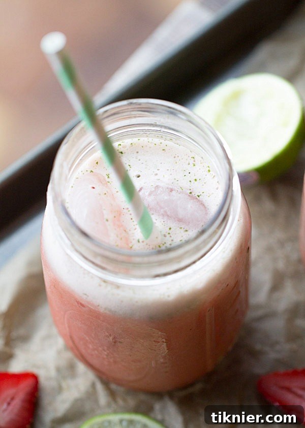 Two glasses of Strawberry Lime Mint Spritzers with Fruttare bars and fresh ingredients