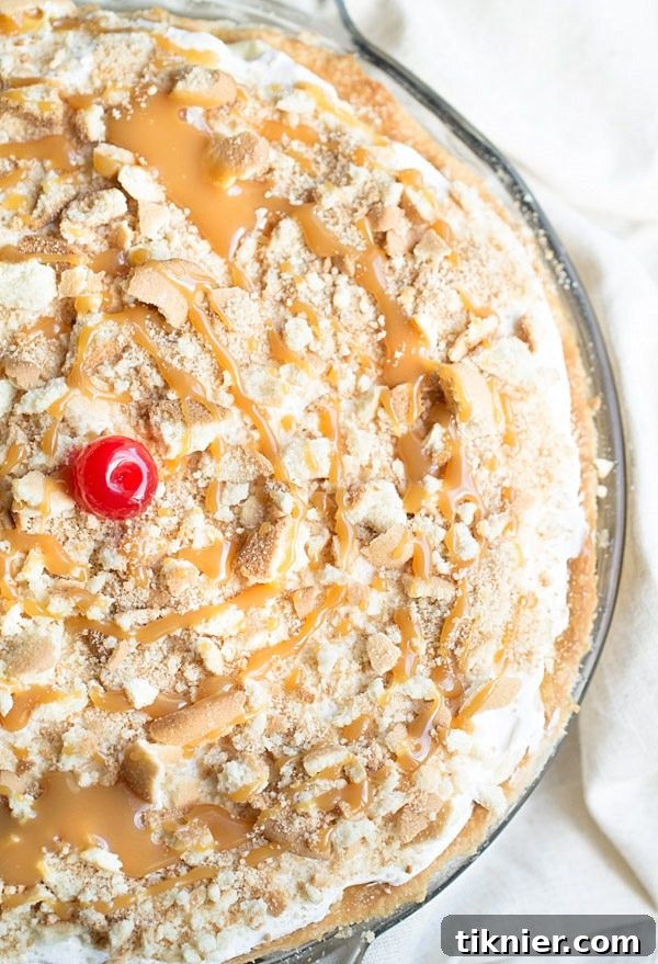 Slice of Decadent Banana Pudding Pie with Caramel on a Plate